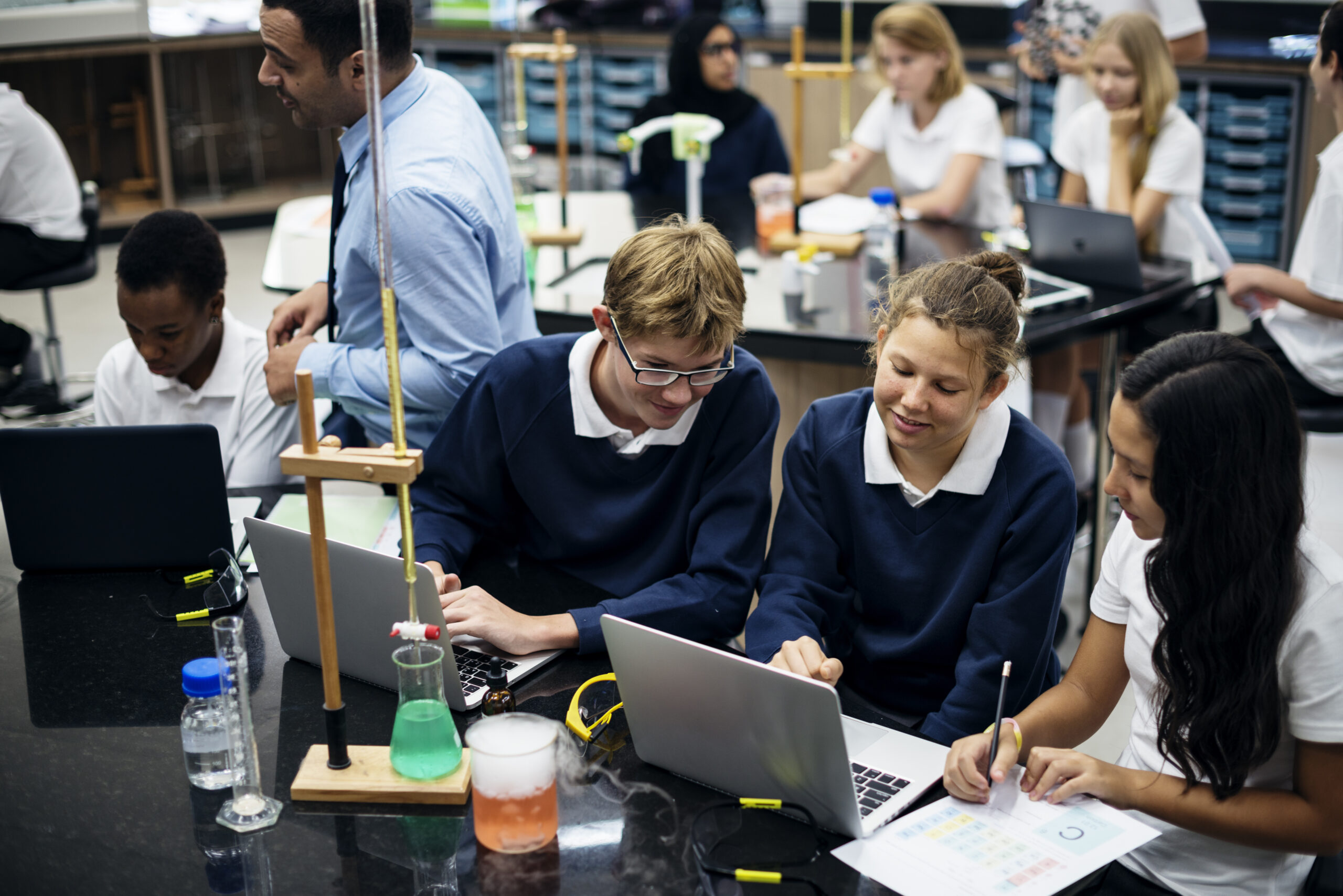 Secondary Science Class room with secondary school students learning and teacher walking around