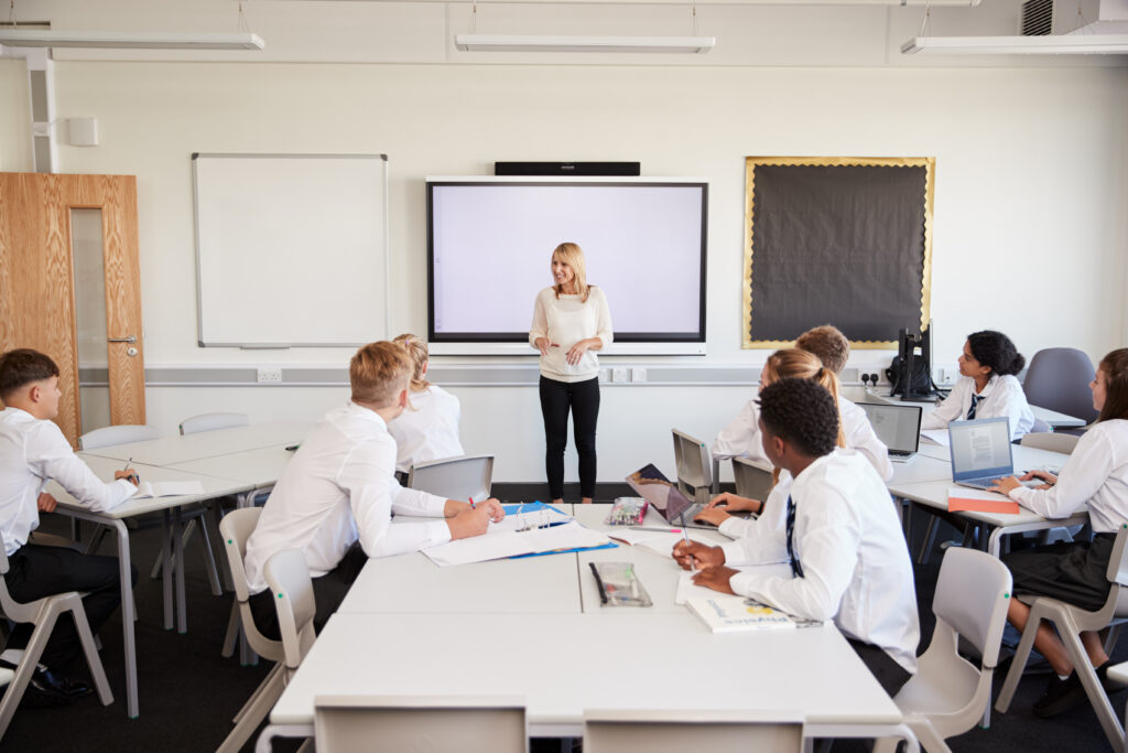 Secondary school teacher, teaching a full class of young adults