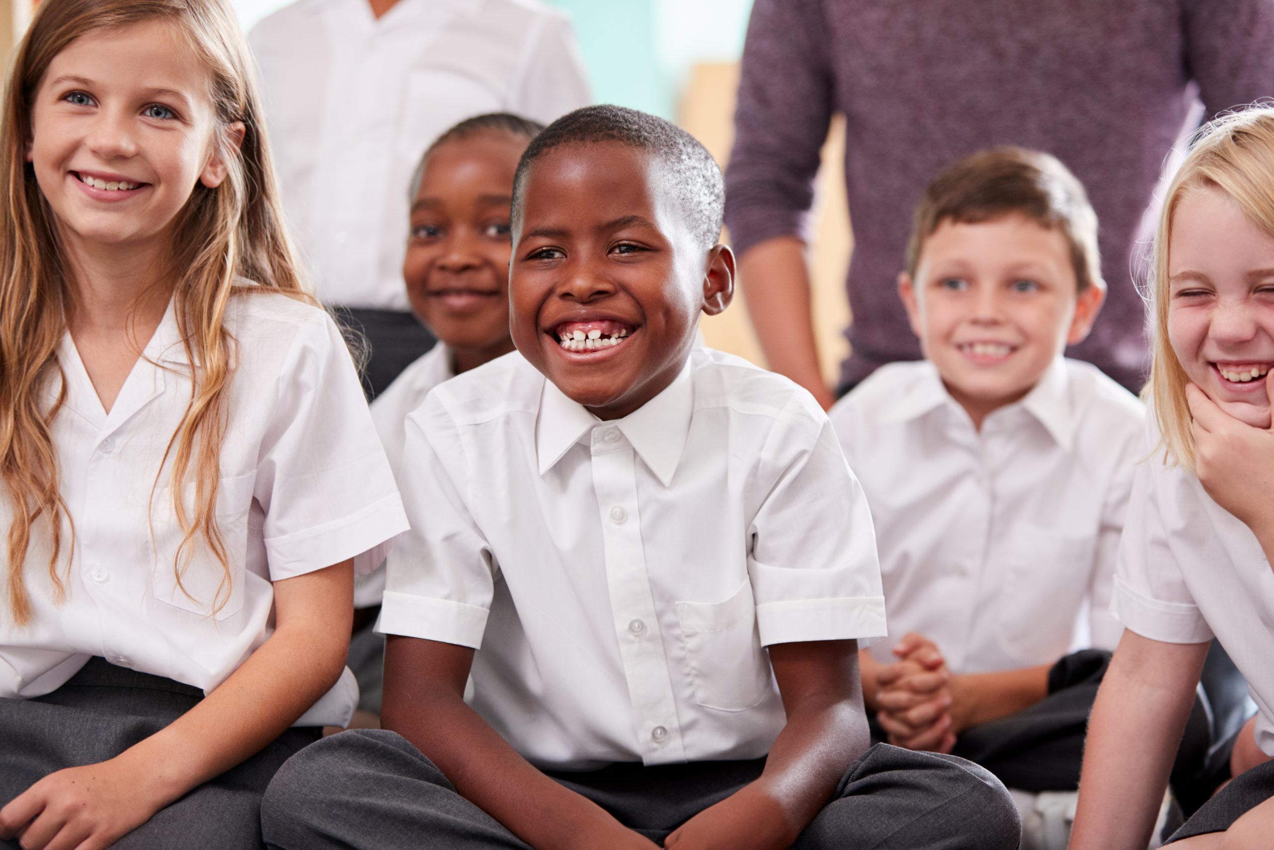 Primary School Children, in a classroom, happy learning.