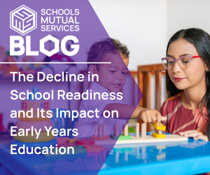 Early years teacher supporting a child with learning activity highlighting school readiness in early education